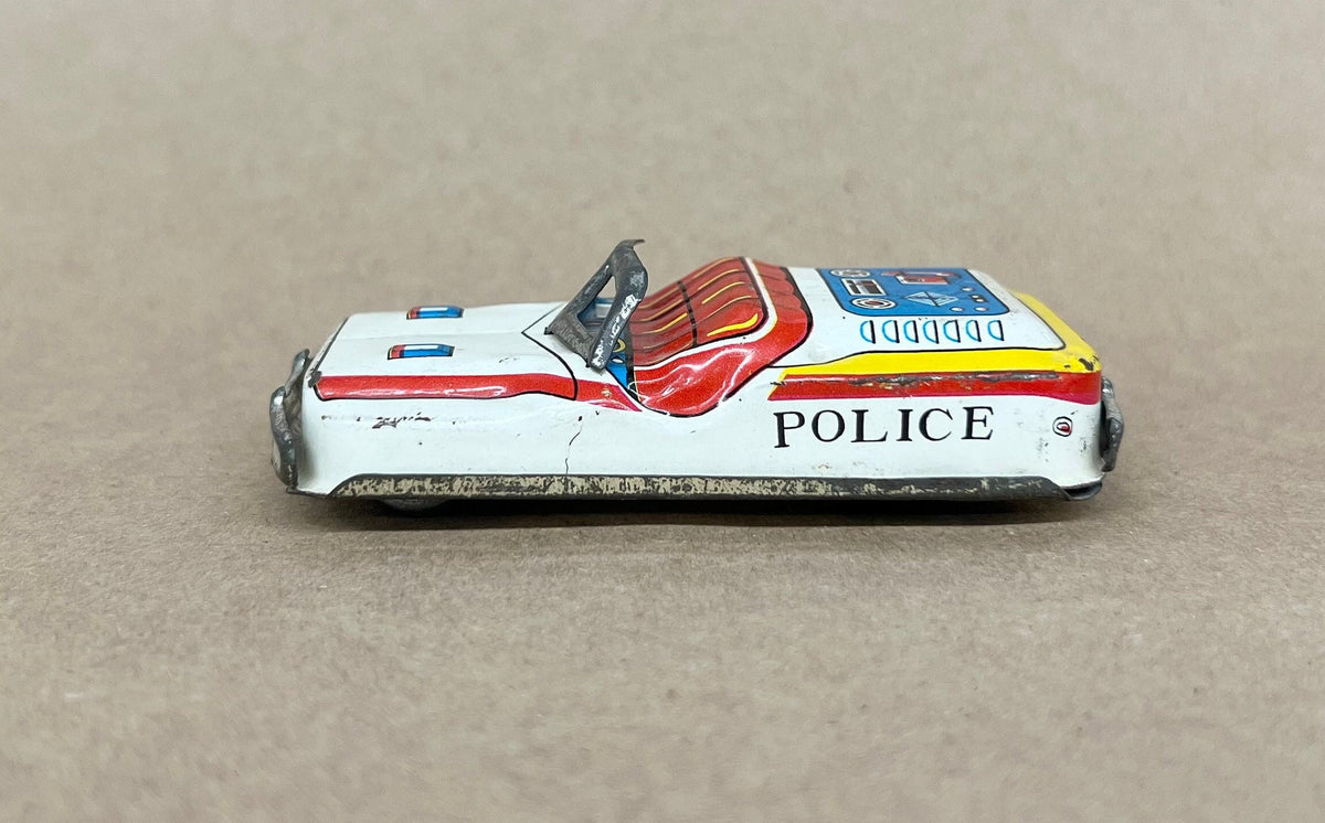 Tin Litho FRICTION Police car- Made in Japan 1950s - Friction sound works - Original Tires - Car runs but not far Police equipment in litho