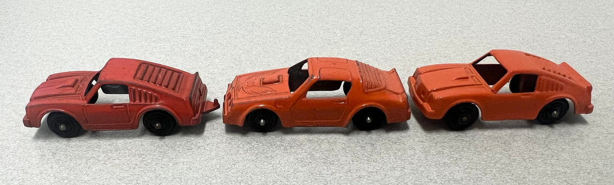 Tootsie Toy Set Of Three- Orange Pontiac Firebird And 2 Ford Mustangs Sold as a set.