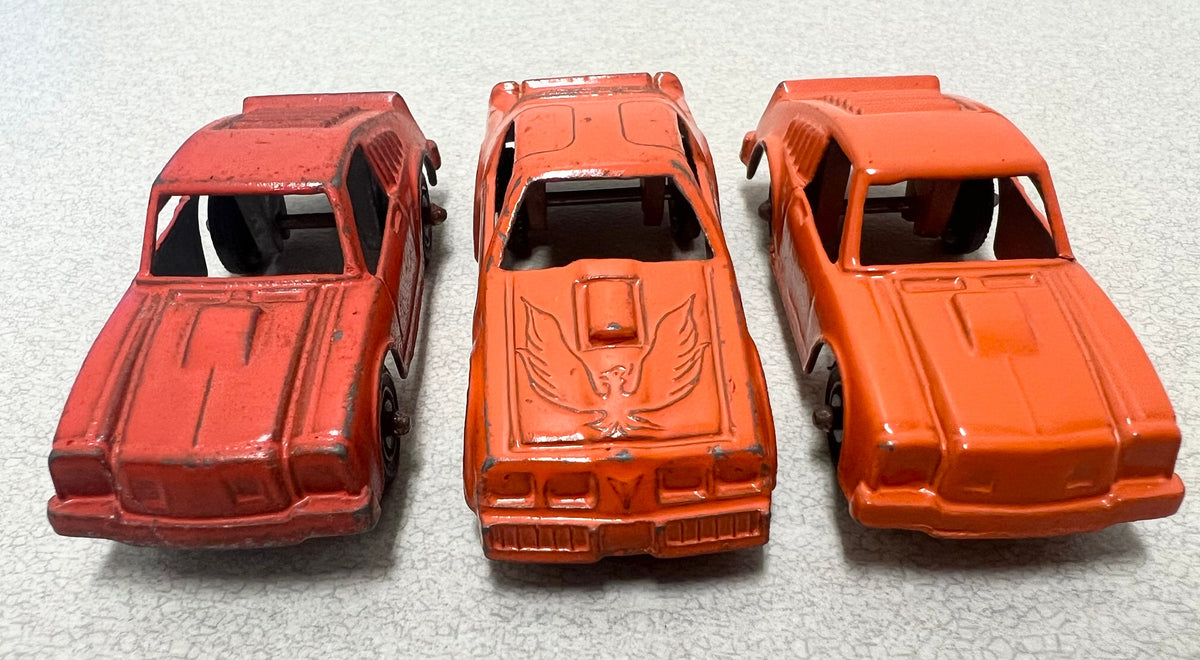 Tootsie Toy Set Of Three- Orange Pontiac Firebird And 2 Ford Mustangs Sold as a set.