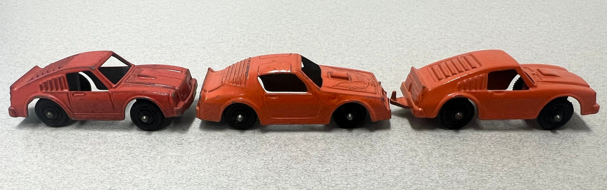 Tootsie Toy Set Of Three- Orange Pontiac Firebird And 2 Ford Mustangs Sold as a set.